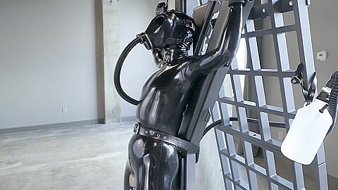 Latexgirl Tied To Cross And Vibed While Rebreather :: Latex bondage scene with masked woman restrained - free porn video