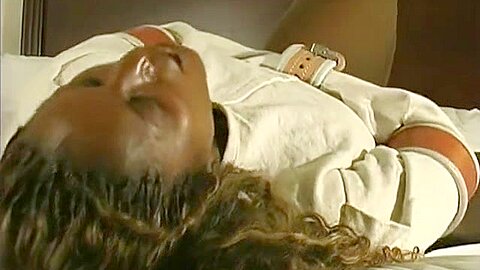Tigra struggles in a straitjacket and leather cuffs - free porn video